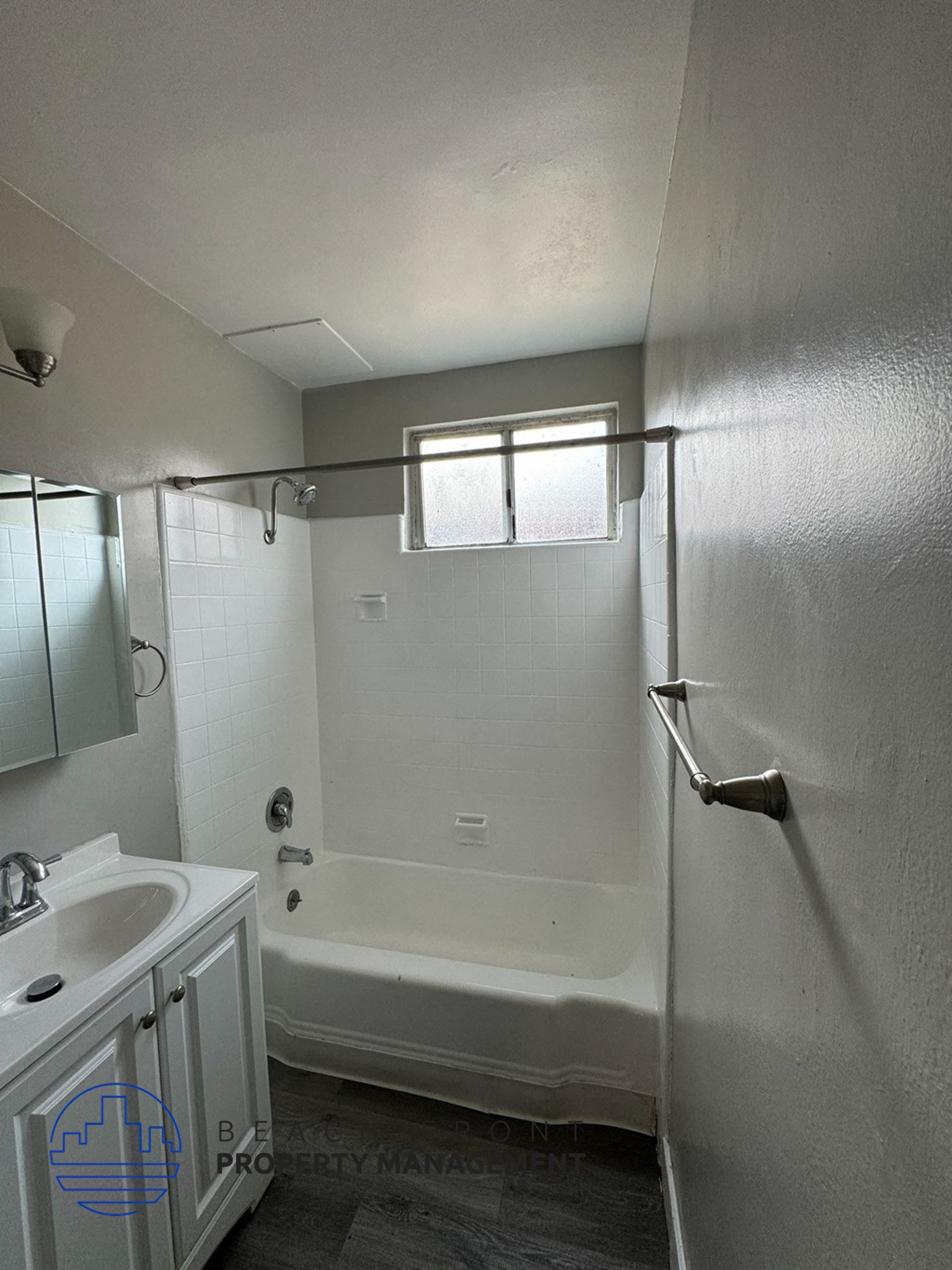 an empty bathroom with a shower and a sink